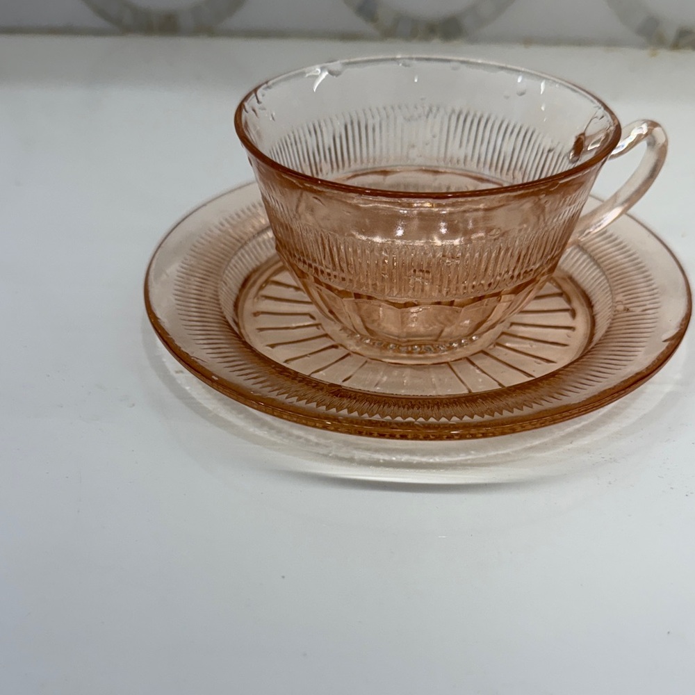 Elegant Pink Glass Teacup and Saucer Set. Compression glass